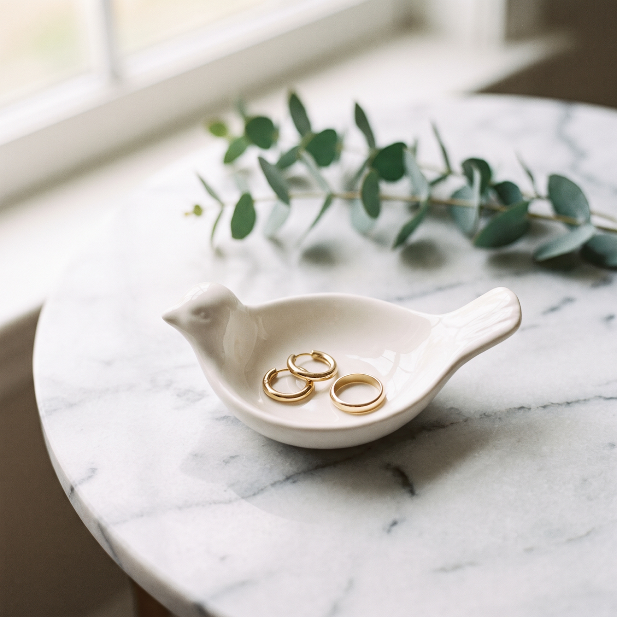 Ceramic bird trinket dish holding jewellery